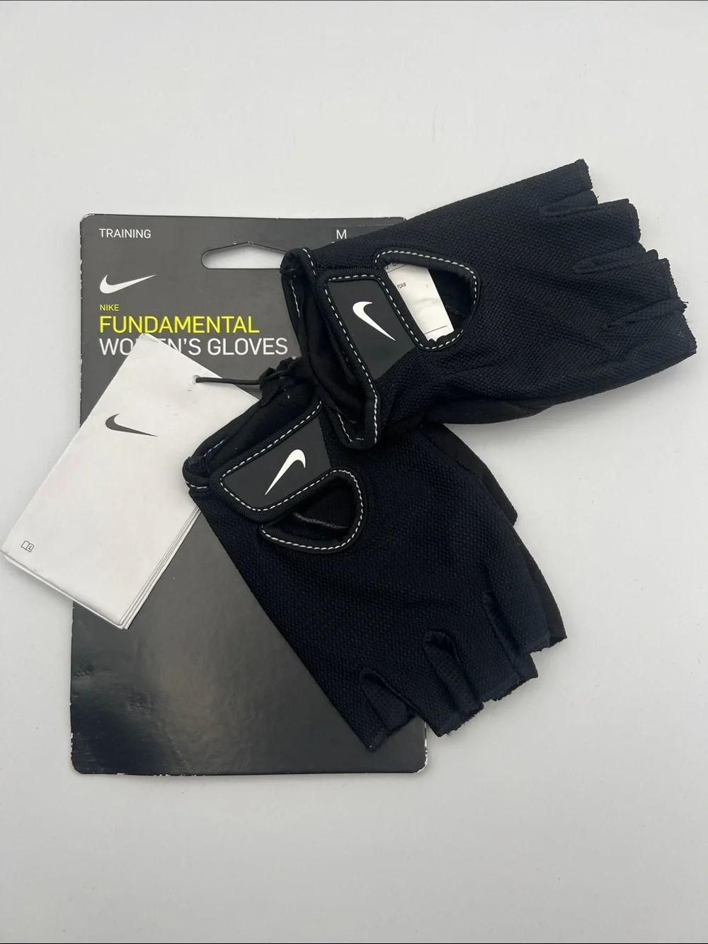 Nike Women's Black Fingerless Workout Gloves with White Swoosh